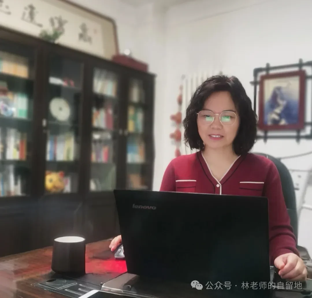 林老师在书桌前，面前放着笔记本电脑